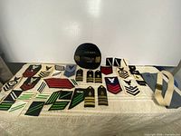 Overall view of lot showing hat, patches, shoulder boards and belt