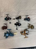 All eight reels and plug laid out on cloth