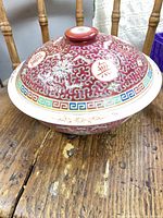 Bowl with lid showing side decoration and finial