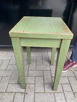 Front view of green distressed side table