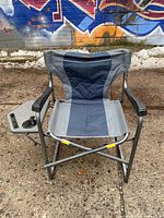 Front view of folding camp chair showing side table and drink holder