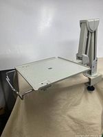 Full view of articulating arm mounted on clamp with tray extended