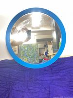 Front view of round mirror with blue frame