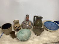 Front view showing eight pottery pieces lined up