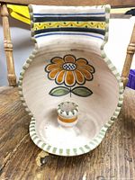 Front view showing floral design and candle cup