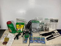 Full lot showing timer, tubing, fertilizer, seed packets and irrigation parts