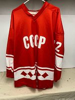 Front view of red CCCP jersey with number 72 on sleeve and patterned striping