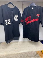 Both jerseys hanging: Smith International on right, Church League 22 jersey on left