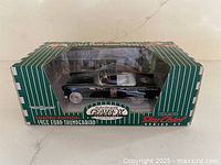 Front and side view of boxed 1956 Ford Thunderbird die-cast car
