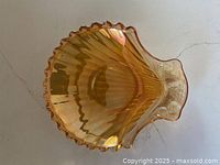 Top view of amber iridescent carnival glass shell dish