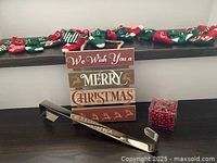 All items together: sign, advent stocking garland on shelf, wreath hanger, red bead garland