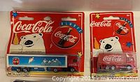 Both blister-packed Coca-Cola trucks side by side