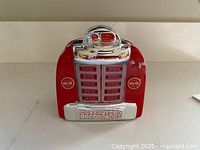 Front view of glass jukebox napkin holder showing Coca-Cola branding and design