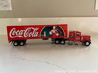 Full side view of Coca-Cola tractor trailer