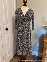 Front view of grey black white jersey knit dress on mannequin