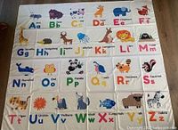 Entire tapestry laid flat showing complete alphabet and animal illustrations