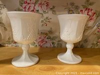Both milk glass goblets side by side showing overall shape and pattern