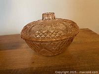 Covered pink glass dish side view