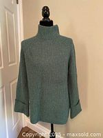 Front view of moss green rib-knit sweater on mannequin