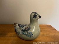 Left three-quarter view of the Tonala bird figurine showing floral wing design