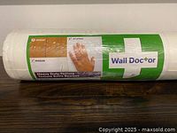 Front label showing Wall Doctor branding and beadboard texture graphic