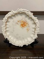 front view showing floral design and scalloped rim