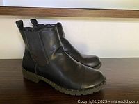 Side view of both black Chelsea boots