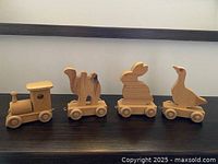 locomotive and three animal cars lined in a row