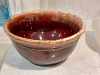 Side view of brown glazed bowl