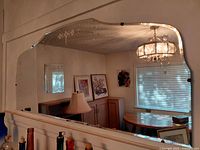 Full view of frameless etched mirror mounted on wall