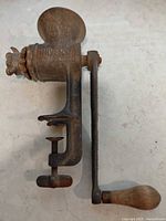 Full view of meat grinder with handle and clamp