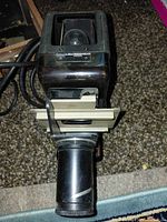 Front view of Leitz Prado projector showing lens barrel and slide gate