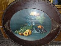 Front view of oval framed still life print