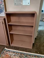 Front view of painted wood bookcase with two interior shelves
