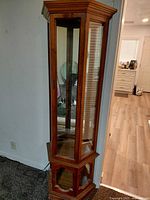 Full view of wooden glass curio cabinet