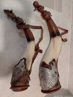 Both horn flasks side by side showing overall design, length comparison, straps and stoppers