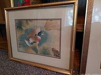 Framed duck print showing single duck with lotus leaves, bamboo-style frame