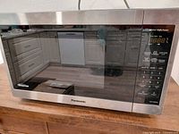 Front view of Panasonic microwave showing brand and stainless trim