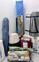 Group shot of tents, canopy, pads, airbeds, pillows