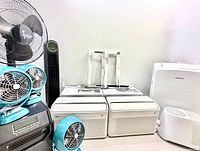 Group shot of all climate control items including Midea window ACs, Hisense portable AC, fans, heater