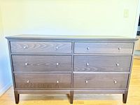 Front view showing six drawers and knobs