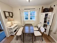 Dining table, two chairs, bench, white console with lamp, tall pantry cabinet