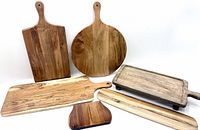 Seven wooden boards laid out showing variety of shapes and sizes