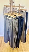 Front view of multiple pairs of pants on hangers showing color assortment