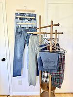 Overall lot on rack showing jeans, chinos, plaid and track pants, navy short