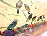 Close-up of painted metal birds on branches