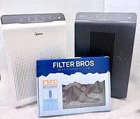 Front view of both Winix air purifiers and boxed carbon filters