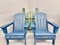 Front view of two blue chairs with green chair folded behind