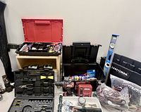 Overview of workshop boxes, tools, drill, level, hardware laid out