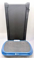 Treadmill stored upright behind LifePro vibration plate